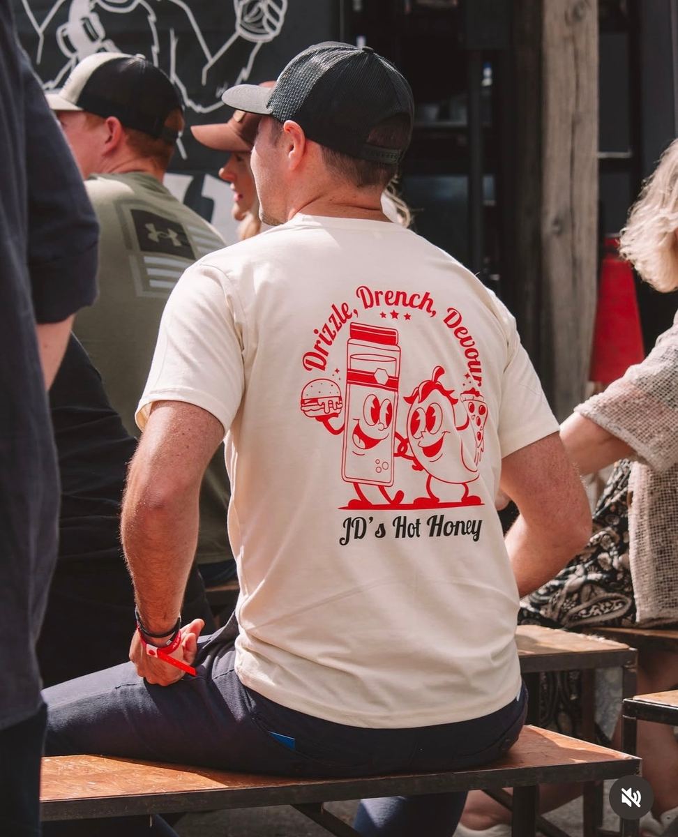 Man in a JD's Hot Honey 'Drizzle, Drench, Devour' t-shirt